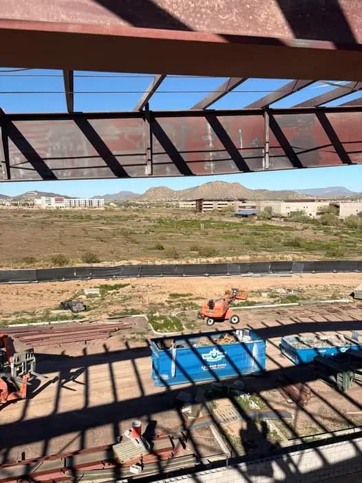 Elevated view through rusted steel beams at the Fire and Ice Arena project